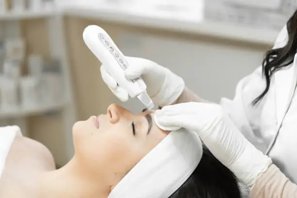 Photo of Clinically clean skin: with this procedure of ultrasonic facial cleansing from professional, woman gets feeling purity and freshness after clinical cleansing skin in a beauty clinic at cosmetologist