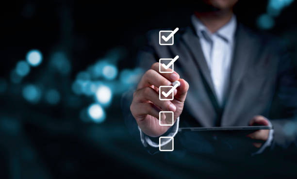 istock Businessman use pen to tick correct sign mark in checkbox for quality document control checklist and business approve project concept. 1498402213