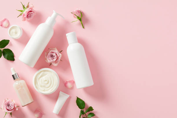 istock White shampoo bottle mockup, essential oil, moisturizer cream, rose blossoms, on pink background. Natural skin care cosmetics. 1498402681