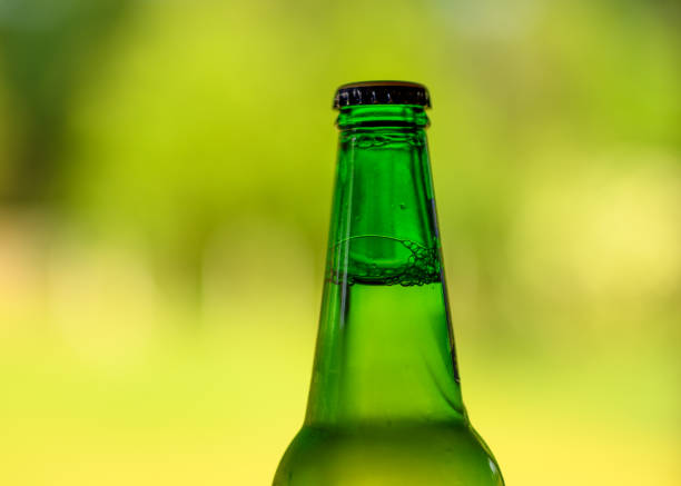 istock Green closed bottle with a cap on a blurred background 1498403994