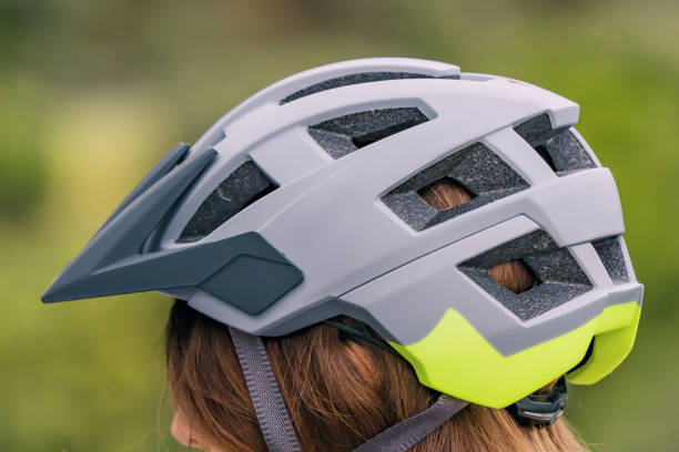 istock Woman wearing protective bicycle helmet while riding mtb bike 1498404074