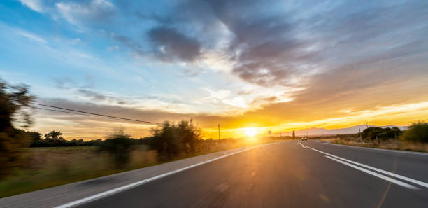 istock Empty long road on a sunny summer day at bright sunset 1498406515