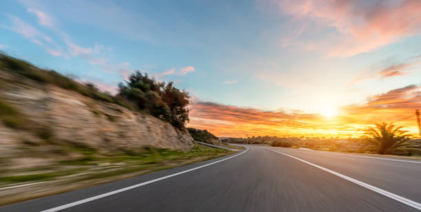 istock Empty long road on a sunny summer day at bright sunset 1498406529