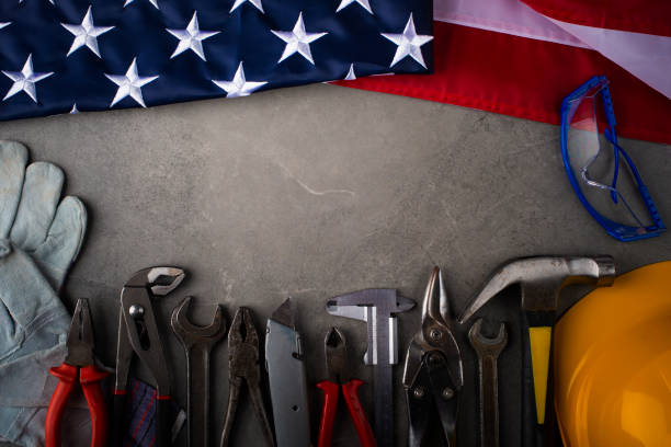 istock Tools hardhat and us flag on concrete cement background labor day banner mockup 1498406950