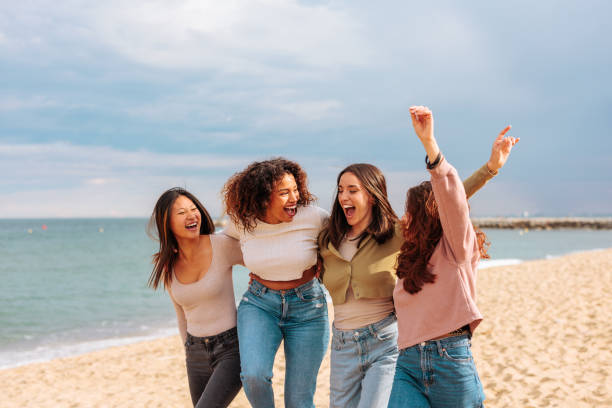 istock Diverse young women having fun on beach. 1498408554