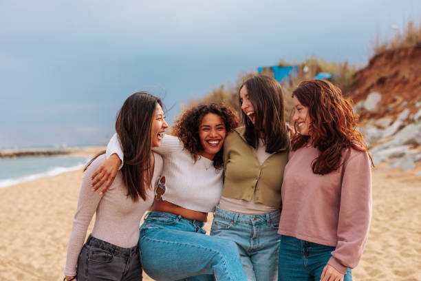 istock Four diverse young girls standing together at beach. 1498408581