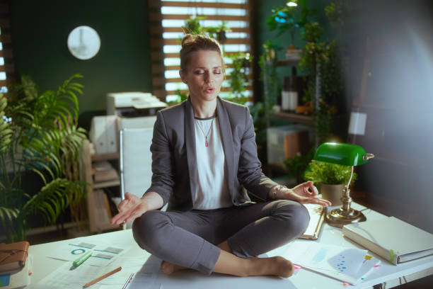 istock relaxed modern business woman at work meditating 1498410613