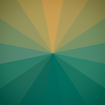 Transition from ocher to green radial symmetry background made of paper triangles.