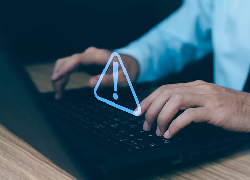 Businessman Using Computer Laptop With Triangle Caution Warning Sing ...