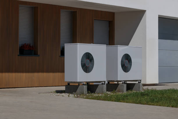 Renewable energy concept with air source heat pumps on modern house front. Modern house front with installed air source heat pumps. Concept of renewable energy refrigeration business air conditioner factory stock pictures, royalty-free photos & images