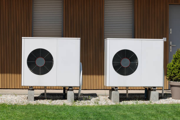 Modern house with renewable energy: air source heat pumps installed on the front.