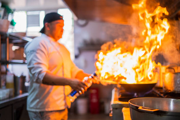 istock Chef is preparing a frying pan in a kitchen 1498418355