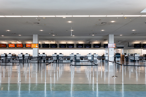 Wide angle view of an empty airport check-in counter.