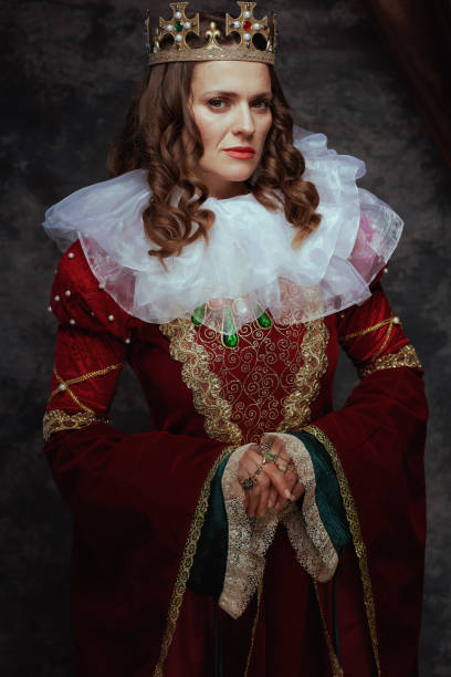 istock medieval queen in red dress with white collar and crown 1498422200