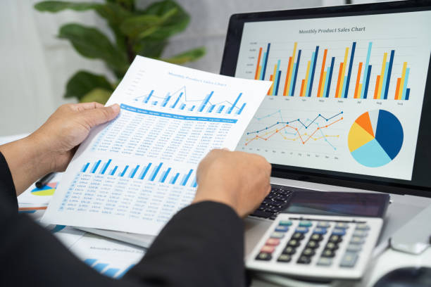 istock Asian accountant working and analyzing financial reports project accounting with chart graph in modern office, finance and business concept. 1498423100