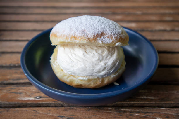 delicioso choux cream (folhados de creme) em um prato - baked bread breakfast brown - fotografias e filmes do acervo