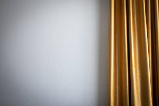 Close-up of wavy golden brown curtains.