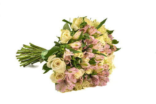 Formed bouquet of blooming rose buds and alstroemerias on a white background. Copy space.