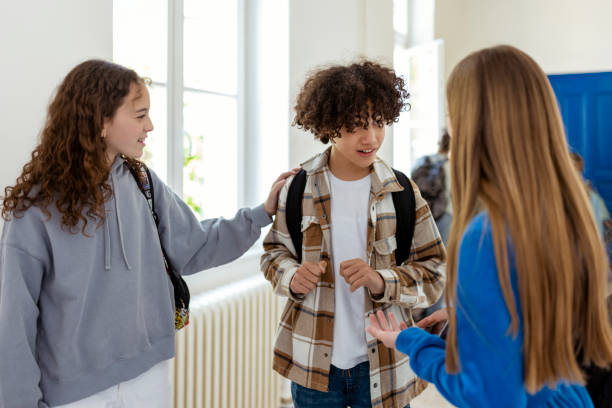 istock Students Talking Together in a School Hallway 1498428282