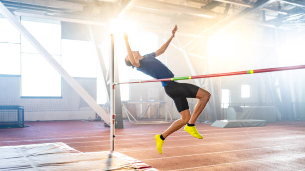 istock Sportsman high jumping through pole 1498428849
