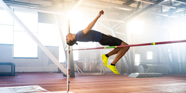 istock Sportsman high jumping through pole 1498428850