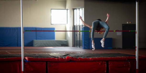 istock Sportswoman high jumping through pole 1498428870