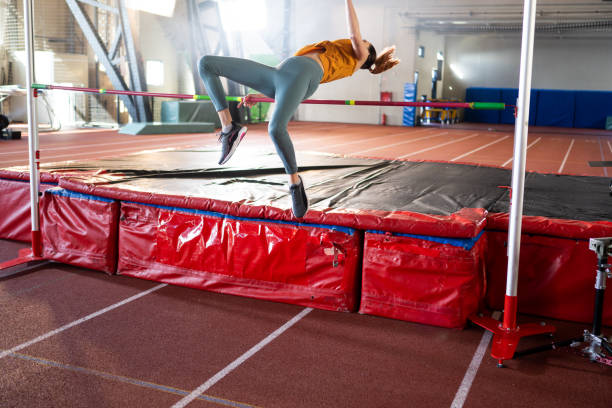 istock Sportswoman high jumping through pole 1498428927