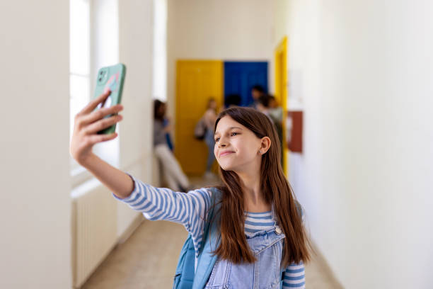 istock Schoolgirl Taking Selfie 1498429101