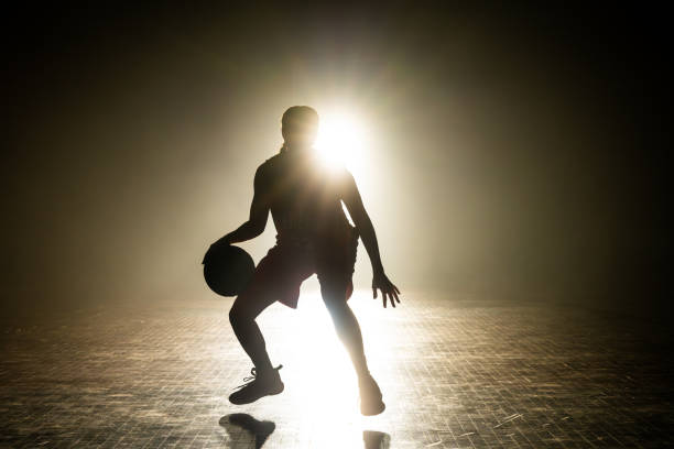 istock Female basketball player silhouette training 1498429158