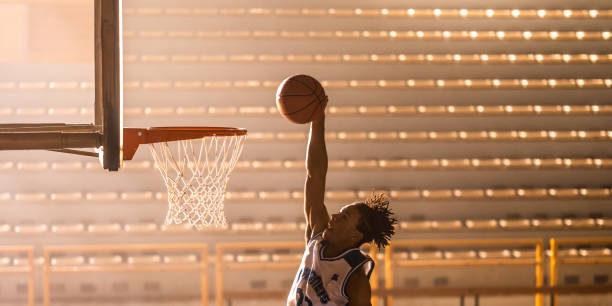 istock Basketball player throwing ball through hoop 1498429184