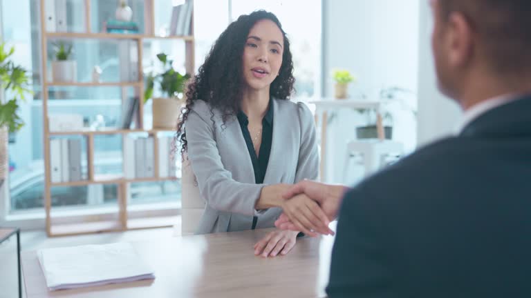 Business people, handshake and interview in meeting, hiring or partnership at the office. Woman recruiter shaking hands with businessman for corporate introduction, deal or agreement at the workplace