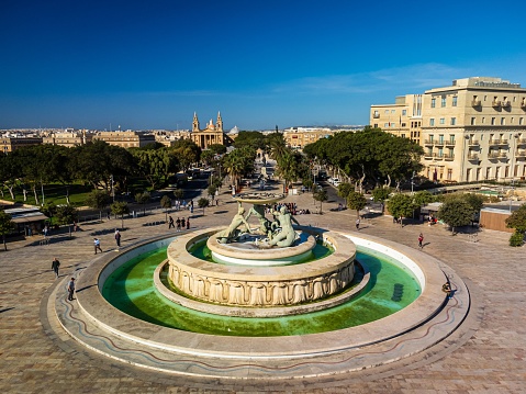 The Triton Fountain surrounded by buildings in Valletta, Malta
