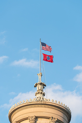 USA Flag and Tennessee State Flag Flying Atop the Tennessee State Capitol in Nashville, Tennessee