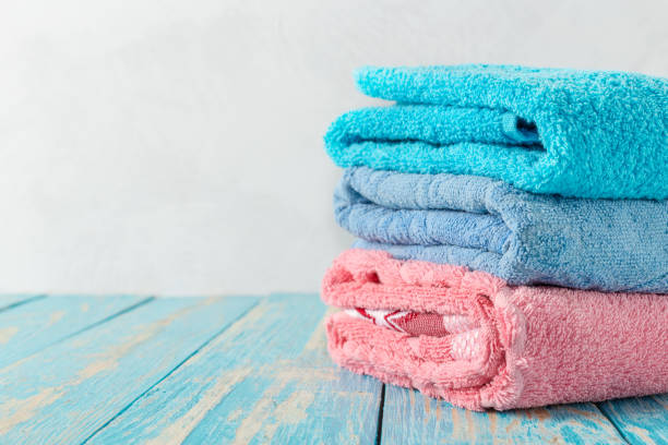 istock Stack of bath towels on wooden table with copy space 1498436044