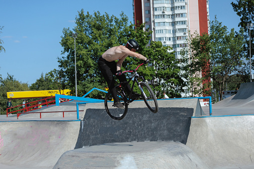 Rider is jumping in the skatepark. Bicycle jumping