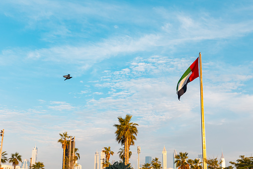 United Arab Emirates, Dubai, La Mer Beach, April 2023: Beautiful place with shops, restaurants, cafes at the Beach,  15 minutes far from Down Town. National Flag of the emirates at the entrance of the area.