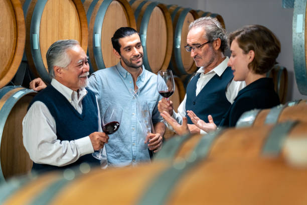 istock Group of People tasting wine in wine cellar. 1498436468