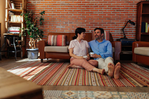 istock Happy couple drinking coffee on apartment floor 1498438146