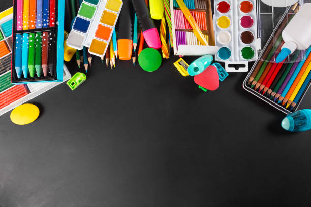 istock School supplies bottom border on a chalkboard background 1498440123