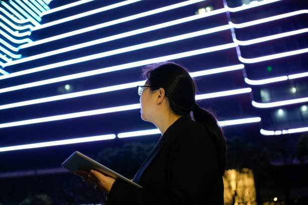 istock Asian businesswomen use tablets under the building 1498441597