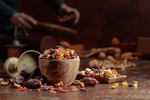 istock Various dried fruits and nuts on a kitchen table. 1498442603