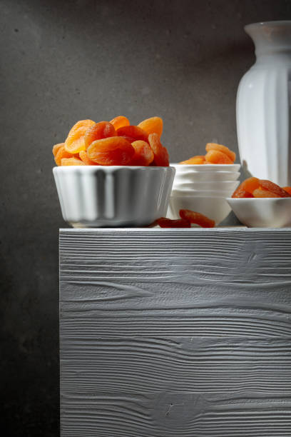 Dried apricots on a white wooden table.
