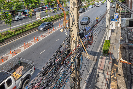 Bangkok, Thailand - March 23th 2023: Typical Asian cable work with a confusing mesh of cables in the center of the capital of Thailand