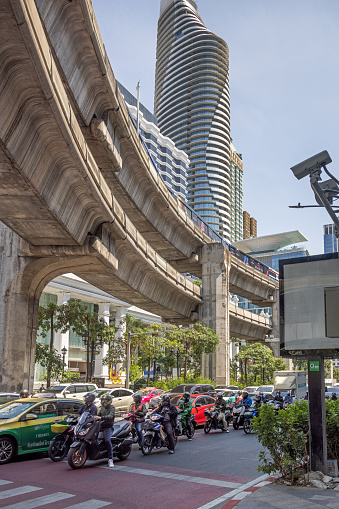 Bangkok, Thailand - March 29th 2023: Traffic under a elevated highway in the center of the capital of Thailand