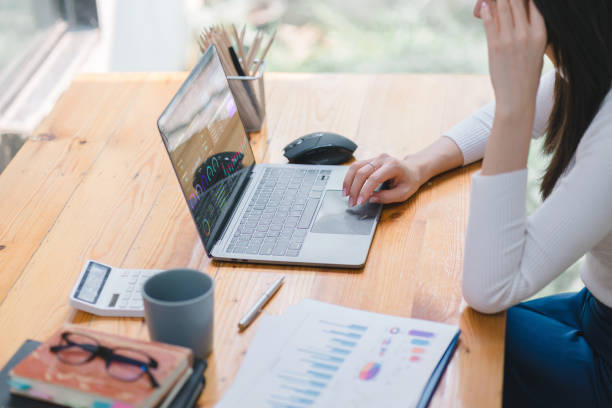 istock Businesswoman accountant working with information database to analyze market data, balance sheets,accounts,and net profits in order to plan new sales strategies and increase production capacity. 1498449191