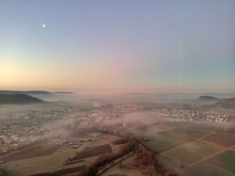 An aerial stunning view of a foggy sunset over Oberstenfeld, Germany