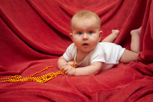 istock Infant baby with golden skein beads 1498452095