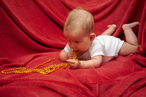 istock Infant baby with golden skein beads 1498452100