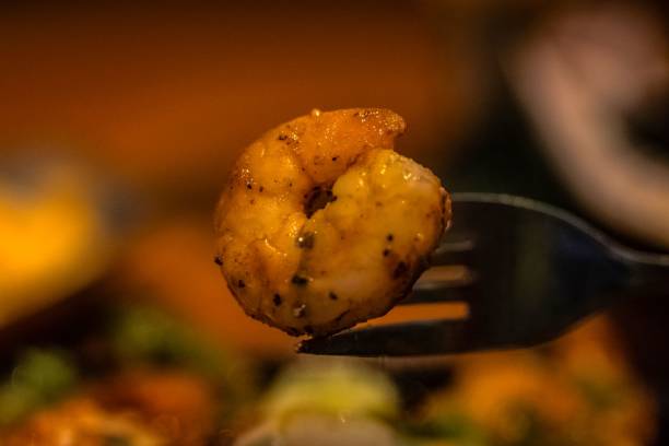 a piece of food on a fork over some food dishes