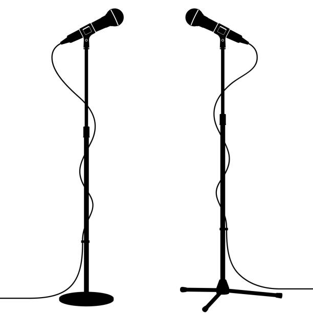 istock Silhouette of Stage Microphones With Round Base and Tripod Stands 1498453928